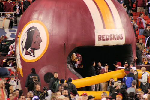 The Skins run out of tunnel, through helmet, onto FEDEX Field.